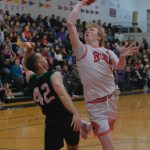 Haines Kyle Fossman (42) defends a scoring shot by Hoonahs Sean Oliver during Haines 75-70 B Bracket elimination game win Friday at the 76th Annual Juneau Lions Club Gold Medal Basketball Tournament in Juneau-Douglas High School: Yadaa.at Kalés George Houston Gymnasium. (Klas Stolpe / Juneau Empire
