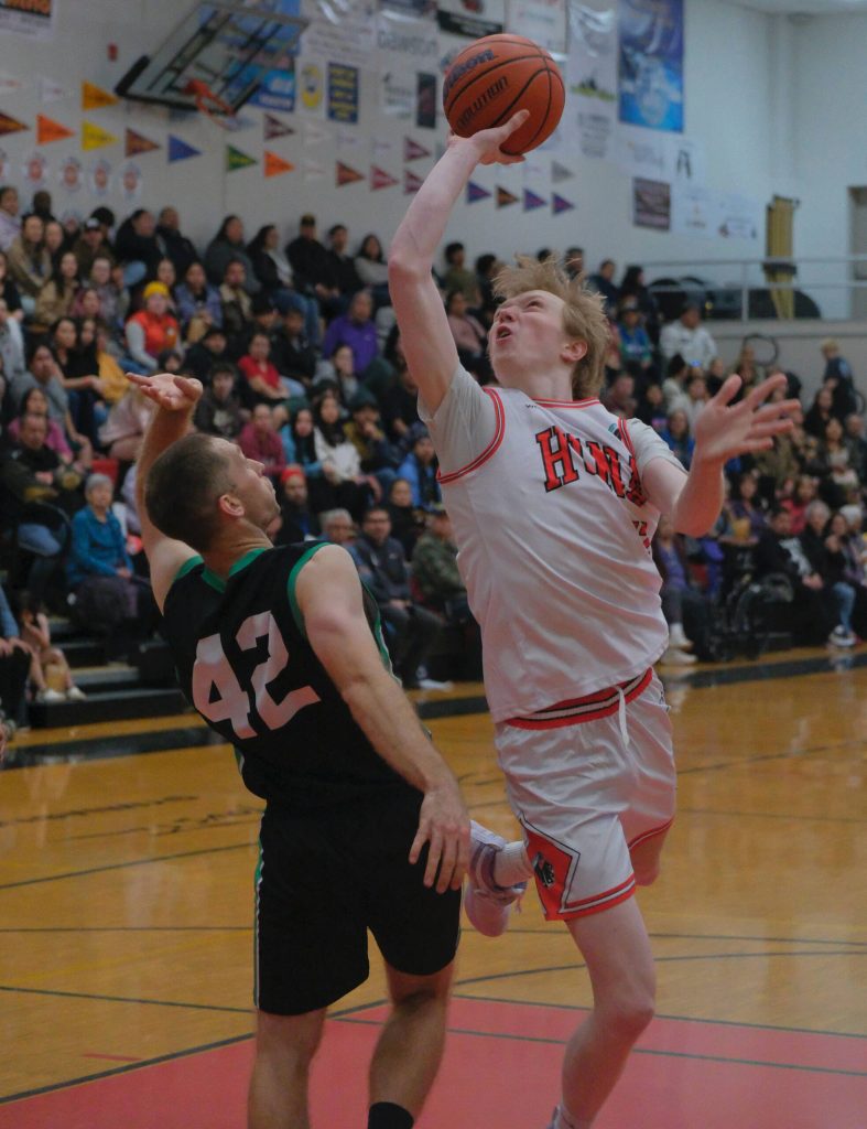 Haines Kyle Fossman (42) defends a scoring shot by Hoonahs Sean Oliver during Haines 75-70 B Bracket elimination game win Friday at the 76th Annual Juneau Lions Club Gold Medal Basketball Tournament in Juneau-Douglas High School: Yadaa.at Kalés George Houston Gymnasium. (Klas Stolpe / Juneau Empire