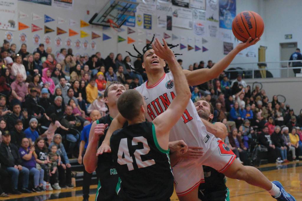 Hoonahs Kayden Lamebull-Ingram (11) is fouled by Haines Kyle Rush (behind) while Tyler Swinton and Kyle Fossman defend during Haines 75-70 B Bracket elimination game win Friday at the 76th Annual Juneau Lions Club Gold Medal Basketball Tournament in Juneau-Douglas High School: Yadaa.at Kalés George Houston Gymnasium. (Klas Stolpe / Juneau Empire)