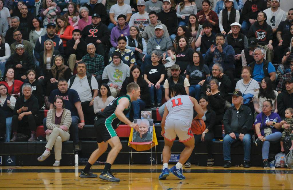 A memorial photo of Harriet Knudson sits in a special chair courtside at Fridays Haines and Hoonah B Bracket game at the 76th Annual Juneau Lions Club Gold Medal Basketball Tournament in Juneau-Douglas High School: Yadaa.at Kalés George Houston Gymnasium. Knudson once said she saw every Gold Medal game since its start in 1946. (Klas Stolpe / Juneau Empire)