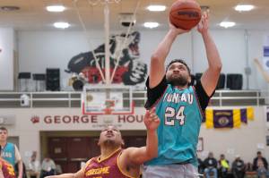 Juneau-AMLs Mahina Toutaiolepo (24) scores over Mt. Edgcumbes Jaylin Prince (42) during the Open Bracket Championship on Saturday at the 76th Annual Juneau Lions Club Gold Medal Basketball Tournament in Juneau-Douglas High School: Yadaa.at Kalés George Houston Gymnasium. (Klas Stolpe / Juneau Empire)