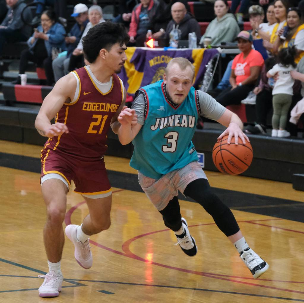 Mt. Edgcumbes RJ Didrickson (21) defends Juneau-AMLs Chase Saviers (3) during the Open Bracket Championship on Saturday at the 76th Annual Juneau Lions Club Gold Medal Basketball Tournament in Juneau-Douglas High School: Yadaa.at Kalés George Houston Gymnasium. (Klas Stolpe / Juneau Empire)