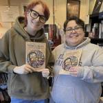 Tidal Echoes editors Annie Kessler and Adonis Scalia holding 2025 editions. (Photo from @uas.tidalechoes on Instagram)