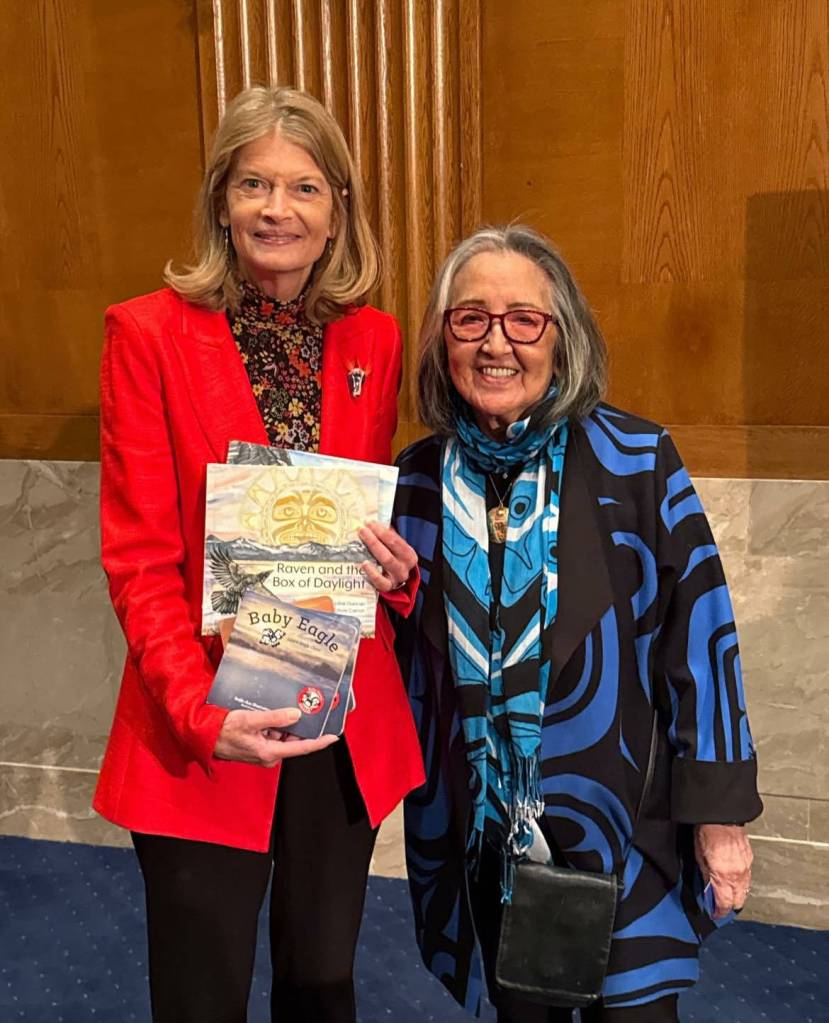 U.S. Sen. Lisa Murkowski (R-Alaska, left) and Sealaska Heritage Institute president Rosita Ḵaaháni Worl (right) stand together in Washington, D.C. Murkowski holds books from the Baby Raven Reads series. (Photo courtesy of Sealaska Heritage Institute)