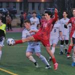Juneau-Douglas High School: Yadaa.at Kalé senior Kellen Chester (10) tips a corner kick against Eagle River during the Crimson Bears 9-1 win over the Wolves on Friday at Adair Kennedy Field. (Klas Stolpe / Juneau Empire)