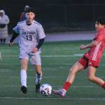 Juneau-Douglas High School: Yadaa.at Kalé junior Fixx Siner strikes a shot against Eagle River during the Crimson Bears 9-1 win over the Wolves on Friday at Adair Kennedy Field. (Klas Stolpe / Juneau Empire)