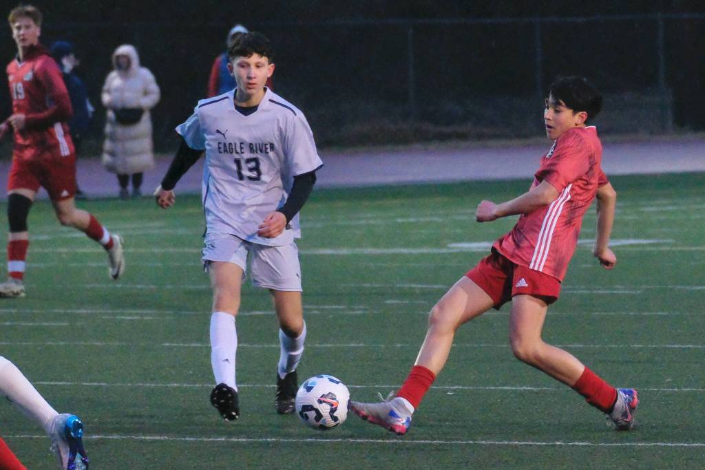 Juneau-Douglas High School: Yadaa.at Kalé junior Fixx Siner strikes a shot against Eagle River during the Crimson Bears 9-1 win over the Wolves on Friday at Adair Kennedy Field. (Klas Stolpe / Juneau Empire)
