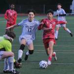 Juneau-Douglas High School: Yadaa.at Kalé junior Kevin Flores-Lopez (6) strikes a shot against Eagle River during the Crimson Bears 9-1 win over the Wolves on Friday at Adair Kennedy Field. (Klas Stolpe / Juneau Empire)