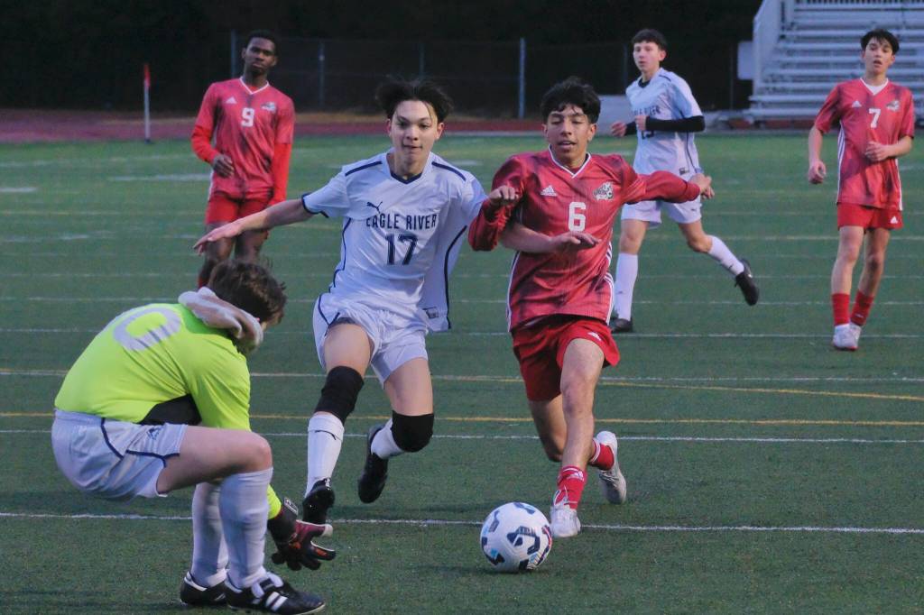 Juneau-Douglas High School: Yadaa.at Kalé junior Kevin Flores-Lopez (6) strikes a shot against Eagle River during the Crimson Bears 9-1 win over the Wolves on Friday at Adair Kennedy Field. (Klas Stolpe / Juneau Empire)