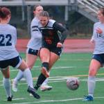 Juneau-Douglas High School: Yadaa.at Kalé freshman Ayla Erickson (16) blasts a shot through three Eagle River defenders during the Crimson Bears 3-0 win over the Wolves on Friday at Adair Kennedy Field. (Klas Stolpe / Juneau Empire)