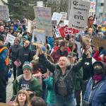 People holding signs and wearing emblems expressing opposition to a wide range of Trump administration actions  including confrontational acts involving Canada, mass firings of federal workers that have largely been found illegal by courts and deportations of people in the U.S. legally  gather in front of the Alaska State Capitol on Saturday. (Mark Sabbatini / Juneau Empire)