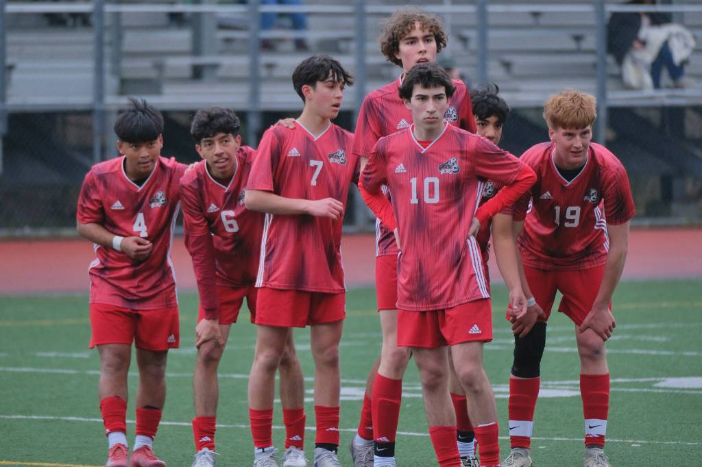 Juneau-Douglas High School: Yadaa.at Kalé sophomore Sam Mazon (4), junior Kevin Flores-Lopez (6), junior Fixx Siner (7), junior Jesper Bennetsen, senior Kellen Chester (10), junior Noah Ault and senior Reed Maier (19) wait for a corner kick against Eagle River during the Crimson Bears 12-0 win over the Wolves on Saturday at Adair Kennedy Field. (Klas Stolpe / Juneau Empire)