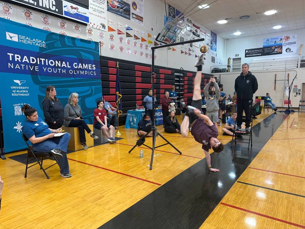 Malcolm Fuette, 17, of Juneau, attempts an Alaskan high kick during the Traditional Games on Sunday at Juneau-Douglas High School: Yadaa.at Kalé. (Mark Sabbatini / Juneau Empire)