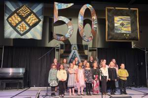 The Alaska Youth Choir sings the official state song during its traditional appearance to open the 50th Alaska Folk Festival on Monday night at Centennial Hall. (Mark Sabbatini)