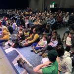 An early crowd of a couple hundred people of all ages watch the opening acts of the 50th Alaska Folks Festival on Monday evening. (Mark Sabbatini / Juneau Empire)
