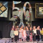 The Alaska Youth Choir sings the official state song during its traditional appearance to open the 50th Alaska Folk Festival on Monday night at Centennial Hall. (Mark Sabbatini)
