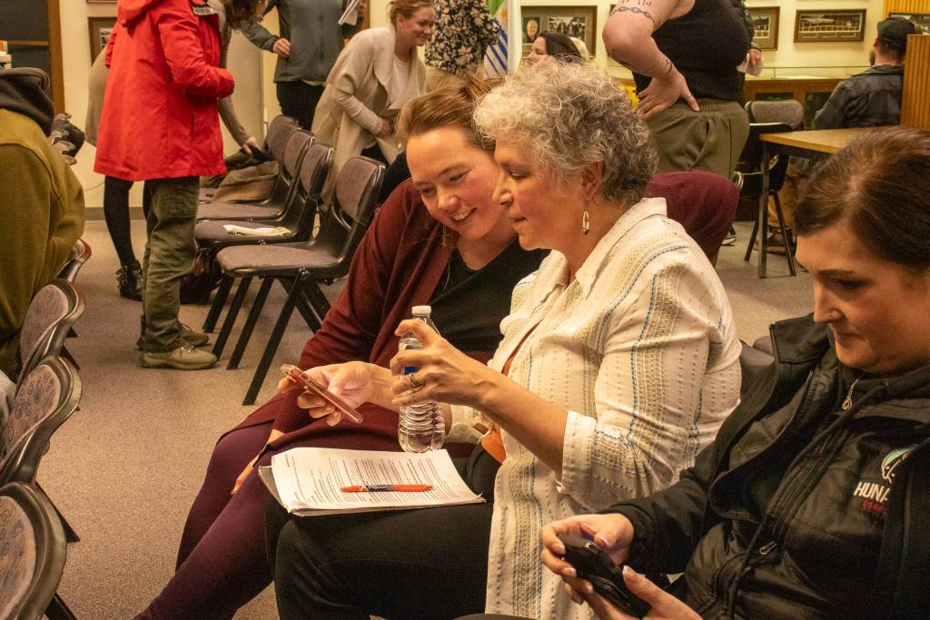 Assembly member Alicia Hughes-Skandijs chats with the vice president of strategic initiatives for Huna Totem, Susan Bell, following the vote on Huna Totems waterfront tideland lease on Monday, April 7, 2025. (Jasz Garrett / Juneau Empire)