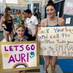 Swimmers had signs written about them by other swimmers during the 2025 Savannah Cayce Southeast Championships over the weekend. Here Auri Jones (age 8) and her swim buddy Emma Fellman (18) show theirs. (Klas Stolpe / Juneau Empire)