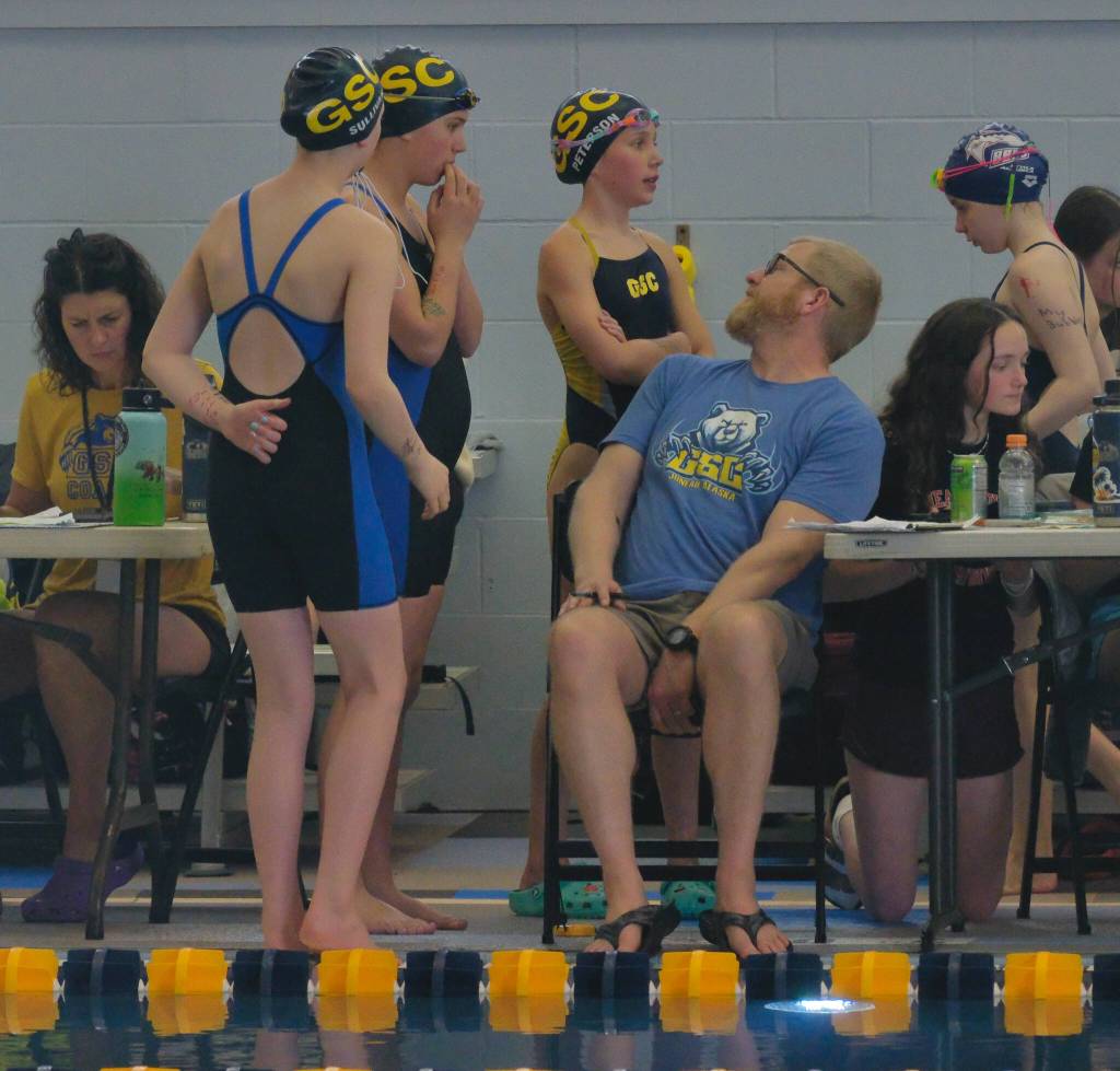 Glacier Swim Club swimmers talk to head coach Scott Griffith during the 2025 Savannah Cayce Southeast Age Group Championships on Sunday at the Dimond Park Aquatic Center. (Klas Stolpe / Juneau Empire)