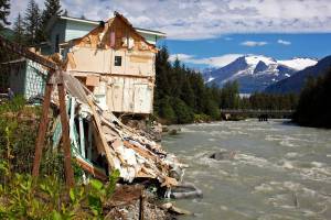 Debris from a home that partially fell into the Mendenhall River due to a record glacial outburst flood remains on the riverbank on Sunday, Aug. 6, 2023. (Mark Sabbatini / Juneau Empire file photo)