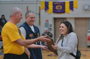 Yakutat's Rose Fraker is presented with the Walter Soboleff Award at the 2025 Juneau Lions Club Gold Medal Basketball Tournament by Steve Brandner, a previous winner, and Lions Club president Tim Wilson. (Klas Stolpe / Juneau Empire)