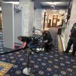 Workers begin to install an airport-style security system inside the front entrance of the Alaska State Capitol on Friday. (Mark Sabbatini / Juneau Empire)