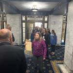 A group of Juneau student protesters taking part in a statewide walkout calling for an increase in education funding are greeted by security officers and other people as they enter the Alaska State Capitol on Friday. (Mark Sabbatini / Juneau Empire)