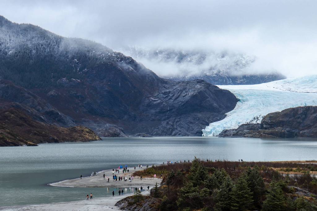 A view of visitors exploring the Mendenhall Glacier Recreation Area taken from the visitor center on Monday, April 14, 2025. (Jasz Garrett / Juneau Empire)