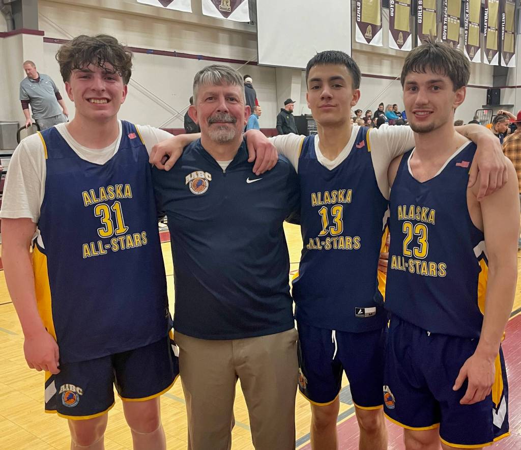 Ketchikan senior Marcus Stockhausen (31), Kayhi coach Eric Stockhausen, Monroe Catholic senior Jett McCullough (13) and Nome Beltz senior Finn Gregg (23) pose at the AABC Senior All-Star Game on Saturday at Anchorages Grace Christian High School. The three players will be teammates at the University of Alaska Fairbanks. (Photo courtesy Eric Stockhausen)