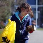 Gerald Thill, 7, inspects a weathered can before placing it in a litter bag during the annual citywide cleanup in 2023. (Ben Hohenstatt / Juneau Empire file photo)