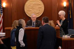 Speaker of the House Bryce Edgmon, I-Dillingham, talks to fellow legislators during a break in budget debates Wednesday, April 16, 2025. (James Brooks/Alaska Beacon)