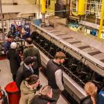 Josh Chevalier, chief engineer of the MV Columbia, opens hot boxes to show the legislators the fuel rack, its connection to the governor, and the individual fuel pumps to each cylinder of each engine, as well as the associated high-pressure fuel piping to the fuel injectors. Each cylinder has one injector, also accessed in the hot box. (Jasz Garrett / Juneau Empire)