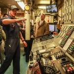 Josh Chevalier, chief engineer of the MV Columbia, shows legislators the engine control room, and explains the control and monitoring systems on Tuesday, April 8, 2025. (Jasz Garrett / Juneau Empire)