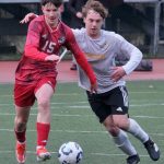 JDHS freshman Bryce Haygood (15) wins a ball from West Valley junior Eli Moore during the Crimson Bears 1-0 win over the Wolfpack on Friday at Adair Kennedy Park. The teams play again at noon Saturday. (Klas Stolpe / Juneau Empire).
