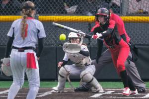 Juneau-Douglas High School: Yadaa.at Kalé senior Tatum Billings attempts a bunt against West Valley during the Crimson Bears 9-4 win over the Wolfpack on Friday at Adair Kennedy Park. The teams play again at 2 p.m. and 4 p.m. Saturday. (Klas Stolpe / Juneau Empire).