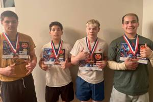 Juneau Youth Wrestling Club members, left-to-right, Jaxin Jim (JDHS sophomore), Caleb Aube (JDHS freshman), Colton Cummins (JDHS senior) and Hayden Aube (JDHS senior) pose with their All-American Status diplomas and medals last week at the Adidas National Wrestling Tournament in Independence, Missouri. (Photo courtesy Loren Cummins)