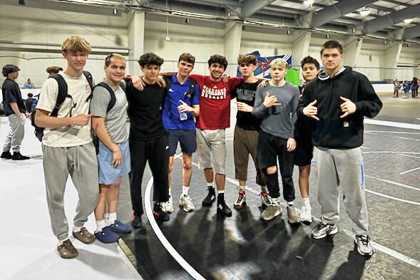 Juneau Youth Wrestling Club grapplers pose with University of Nebraska's 2025 NCAA 149-pound champion Ridge Lovett at the Adidas National Wrestling Tournament last week. From left-to-right are Marlin Cox, Hayden Aube, Landyn Dunn, Oliver Abel, Lovett, coach Carson Cummins, Colton Cummins, Caleb Aube and Jaxin Jim. (Photo courtesy Shelly Crowe)
