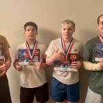 Juneau Youth Wrestling Club members, left-to-right, Jaxin Jim (JDHS sophomore), Caleb Aube (JDHS freshman), Colton Cummins (JDHS senior) and Hayden Aube (JDHS senior) pose with their All-American Status diplomas and medals last week at the Adidas National Wrestling Tournament in Independence, Missouri. (Photo courtesy Loren Cummins)