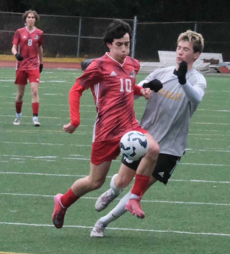 Juneau-Douglas High School: Yadaa.at Kalé senior Kellen Chester (10) works for a ball against West Valley junior Quinn Willis during the Crimson Bears 4-1 win over the Wolfpack on Saturday at Adair Kennedy Park. (Klas Stolpe / Juneau Empire).