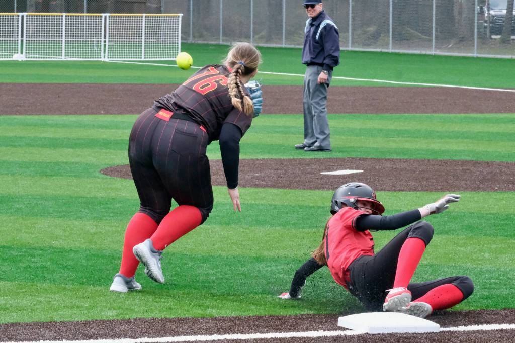 Juneau-Douglas High School: Yadaa.at Kalé senior Tatum Billings slides safely past West Valley third baseman Makayla Anderson (76) during the Crimson Bears 12-6 win over the Wolfpack on Saturday at Adair Kennedy Park. (Klas Stolpe / Juneau Empire).