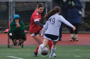 Juneau-Douglas High School: Yadaa.at Kalé junior Kenzie Simonson wins a ball against Eagle Rivers Madalyn Portell (19) during the Crimson Bears 5-0 win over the Wolves at Adair Kennedy Field on April 5. Simonson won the teams Hard Hat award for her play Thursday at Houston in an 8-0 win. (Klas Stolpe / Juneau Empire file photo)