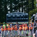 Gastineau Channel Little League players listen as Juneau Police Chief Derek Bos speaks during Saturdays GCLL Opening Day, and field grand reopening and rededication at Adair Kennedy Memorial Park. (Klas Stolpe / Juneau Empire)
