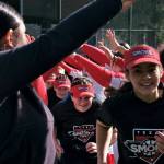 Gastineau Channel Little League youth players are welcomed onto the field by the Juneau-Douglas High School: Yadaa.at Kalé Crimson Bears softball team during Saturdays Opening Day, and field grand reopening and rededication at Adair Kennedy Memorial Park. (Klas Stolpe / Juneau Empire)