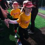 Gastineau Channel Little League youth players are welcomed onto the field by the Juneau-Douglas High School: Yadaa.at Kalé Crimson Bears baseball team during Saturdays Opening Day, and field grand reopening and rededication at Adair Kennedy Memorial Park. (Klas Stolpe / Juneau Empire)