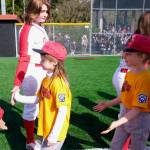 Gastineau Channel Little League youth players are welcomed onto the field by the Juneau-Douglas High School: Yadaa.at Kalé Crimson Bears softball team during Saturdays Opening Day, and field grand reopening and rededication at Adair Kennedy Memorial Park. (Klas Stolpe / Juneau Empire)
