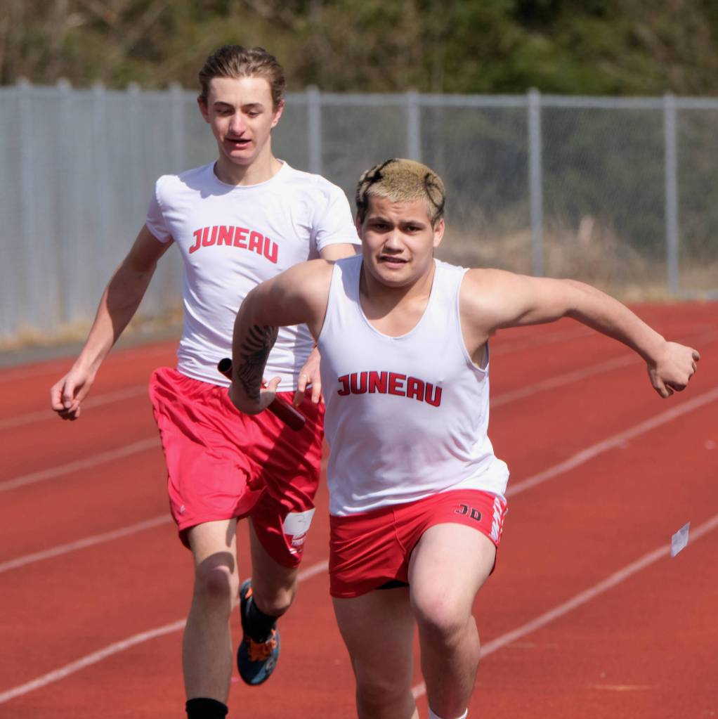 Juneau-Douglas High School: Yadaa.at Kalé senior Hayden Aube takes a baton pass from sophomore Isiaiah Carillo in the boys 4x200 relay during Saturdays Capital City Invitational Track and Field meet at Juneaus Thunder Mountain Middle School field. (Klas Stolpe / Juneau Empire)