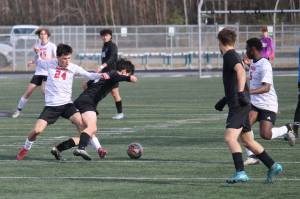 The Juneau-Douglas High School: Yadaa.at Kalé boys soccer team play to a 2-2 tie in their white travel jerseys against Colony on Friday in Palmer. (Photo courtesy Troy Bennetsen)
