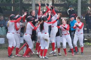 Juneau-Douglas High School: Yadaa.at Kalé junior Gwen Nizich is celebrated at home plate after hitting a home run against visiting Lathrop during the Crimson Bears 16-1 win over the Malemutes on Saturday at Melvin Park. (Klas Stolpe / Juneau Empire)