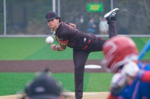 Juneau-Douglas High School: Yadaa.at Kalé junior Riley Fick delivers a pitch against Sitka during the Crimson Bears 4-1 loss to the Wolves on Saturday at Adair Kennedy Memorial Park. (Klas Stolpe / Juneau Empire)