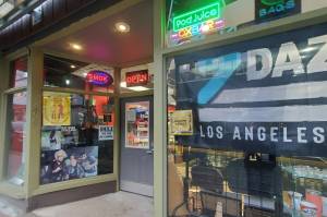 Electronic cigarette products are advertised on April 24, 2025, in the windows of a smoke shop in downtown Juneau. Alaska has no state tax on e-cigarette products, but bills pending in the Legislature seek to change that. (Photo by Yereth Rosen/Alaska Beacon)